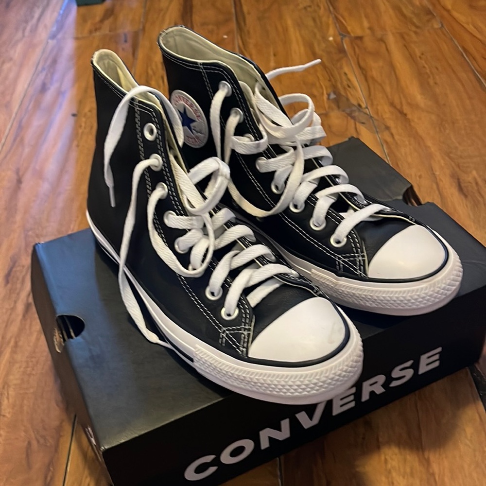 Converse .  black leather . Size 7M /9W